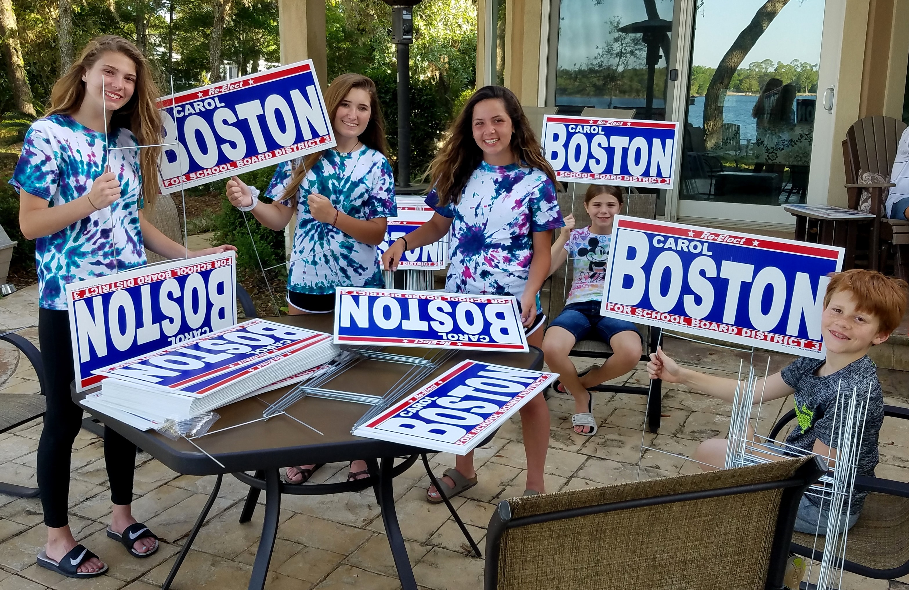 Young supporters holding Carol Boston for School Board District 3 campaign signs